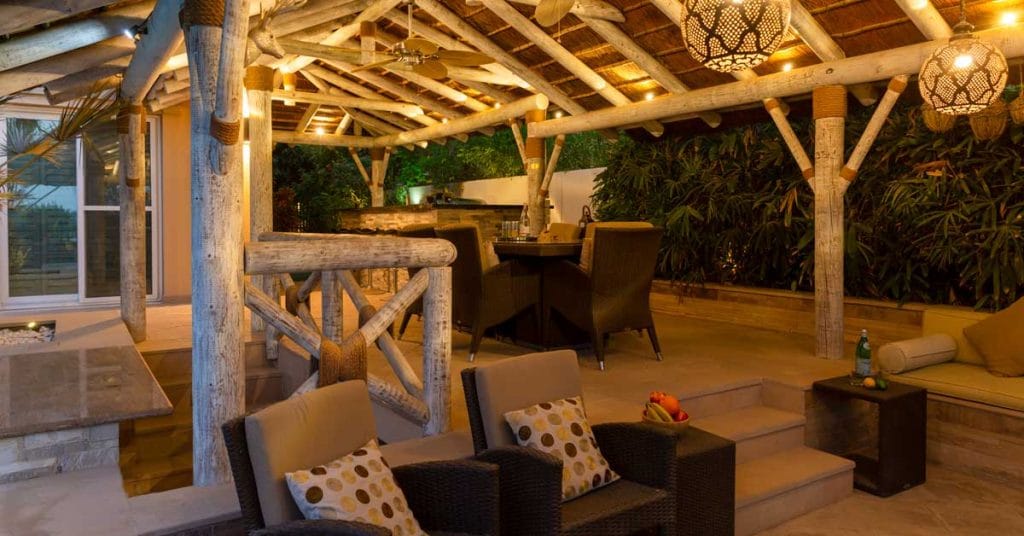 Sunken seating and dining area with a thatched gazebo