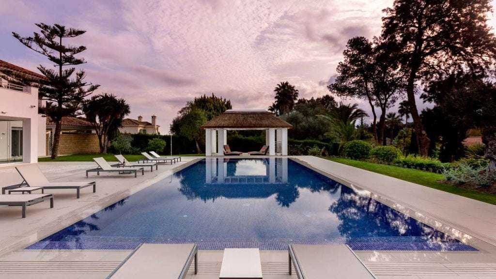 Thatched roof pool cabana on square timber pillars