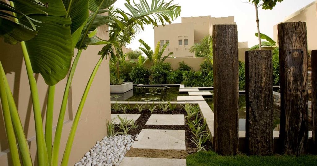 Reclaimed timber sleeper wood combination of hard and soft landscaping.