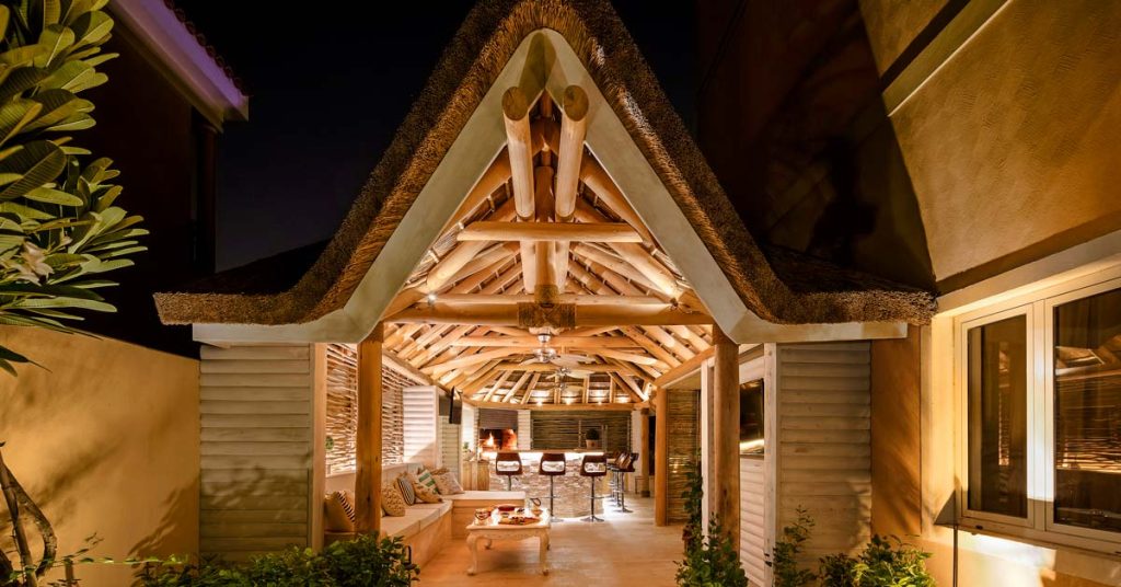 A picturesque Cape Reed thatched gazebo featuring an elegant gabled entrance.