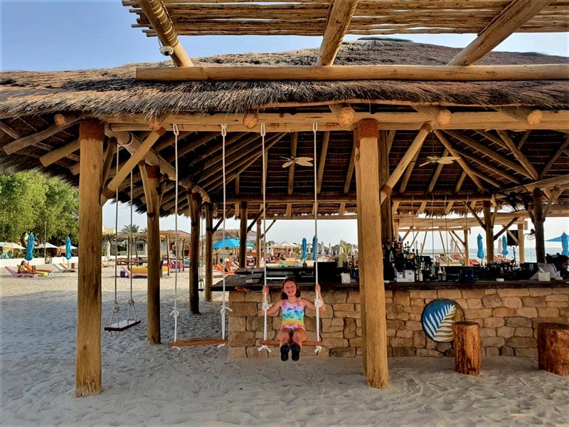 The beach bar offers loads of seating and even a couple of swings.