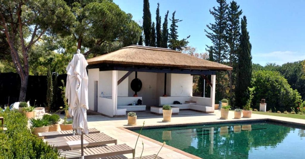 A modern cape reed thatched gazebo on concrete pillars