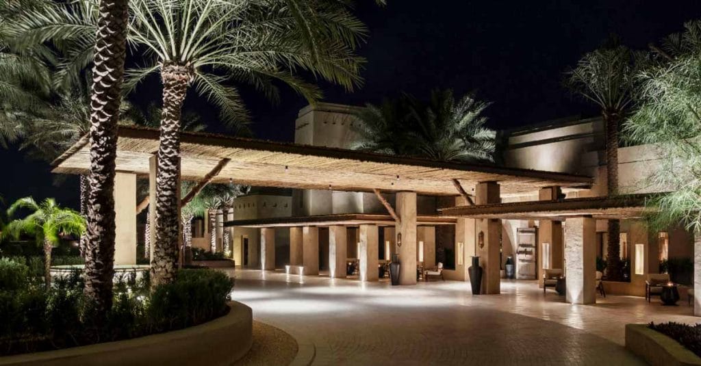 The timber lath entrance of Bab Al Shams Desert Resort invites guests into a world of rustic elegance and traditional Arabian hospitality.