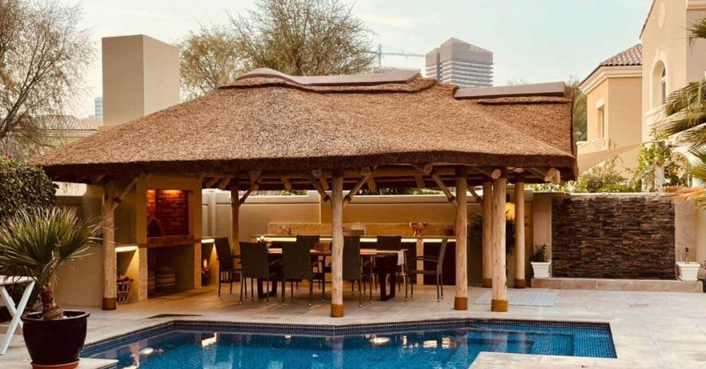 Poolside eucalyptus timber structure with thatched roof