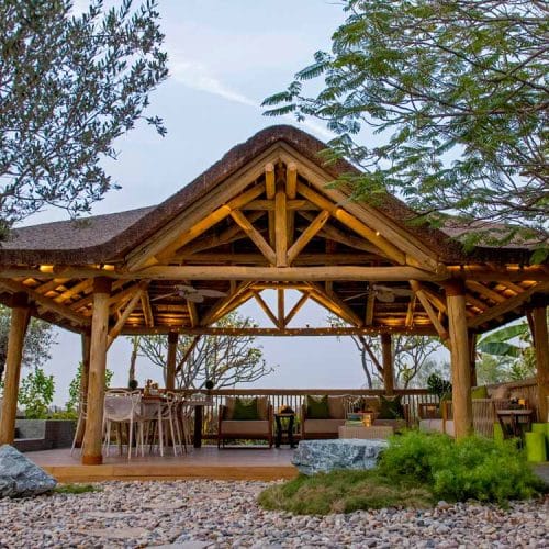 Elevate your outdoor space with our Ibiza thatched roof and timber structure with a gabled entrance.