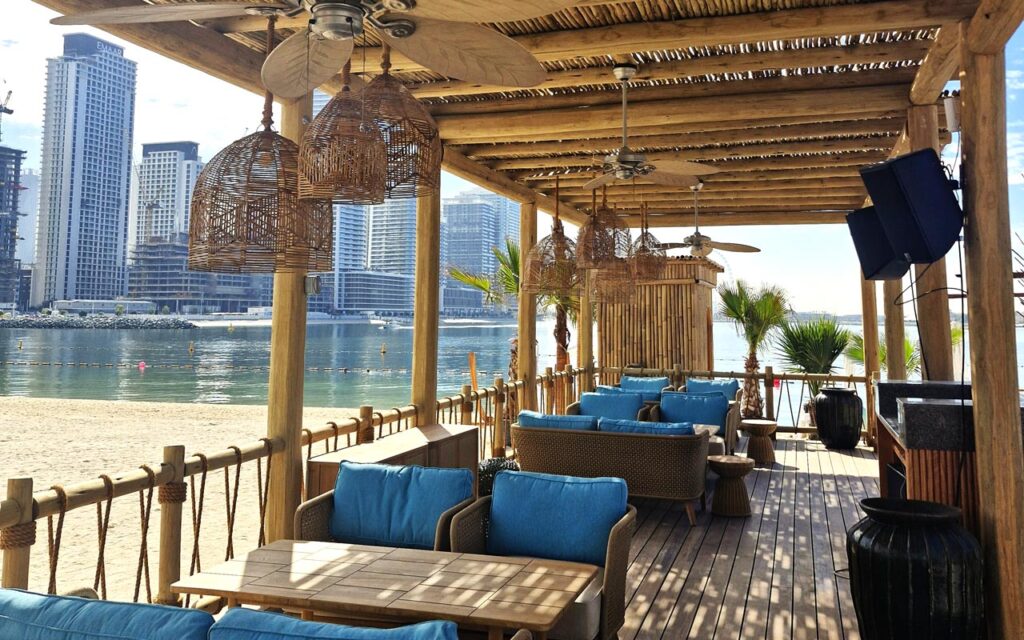 
Koko Bay outdoor dining area with Cape Reed thatched roofing, wooden pergola and lath balustrades at Palm West Beach